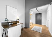 Thumbnail 47 of 99 - A modern home office with a desk, chair, and a large mirror on the wall.at Plant 1 Lofts, N. Newton  