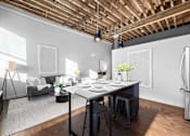 Thumbnail 52 of 99 - A modern kitchen with a dining table set for two.at Plant 1 Lofts, N. Newton, IA  