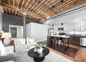 Thumbnail 55 of 99 - A modern kitchen with a wooden ceiling and a dining table with chairs.at Plant 1 Lofts, Iowa   