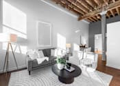 Thumbnail 56 of 99 - A living room with a grey couch, a black coffee table, and a white rug.at Plant 1 Lofts, N. Newton, 50208  