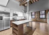 Thumbnail 70 of 99 - A kitchen with a refrigerator, microwave, and oven.at Plant 1 Lofts, Iowa, 50208