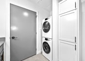 Thumbnail 68 of 99 - A white laundry room with a washer and dryer.at Plant 1 Lofts, Iowa, 50208