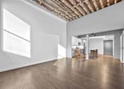 Thumbnail 74 of 99 - A large empty room with wooden floors and white walls.at Plant 1 Lofts, N. Newton, 50208  