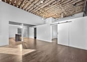 Thumbnail 75 of 99 - A room with wooden floors and ceiling with white walls and doors.at Plant 1 Lofts, Iowa   