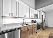 Thumbnail 76 of 99 - A kitchen with white cabinets and stainless steel appliances.at Plant 1 Lofts, N. Newton Iowa   