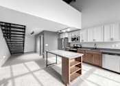 Thumbnail 85 of 99 - A modern kitchen with a white island and stainless steel appliances.at Plant 1 Lofts, N. Newton, IA  