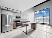 Thumbnail 87 of 99 - A modern kitchen with a large window overlooking the trees.at Plant 1 Lofts, N. Newton  