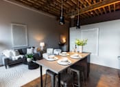 Thumbnail 29 of 99 - A dining area with a table set for four.at Plant 1 Lofts, N. Newton Iowa   