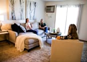 Thumbnail 1 of 57 - three women sitting in a living room talking  at Bristol Ridge, Urbandale, IA, 50322