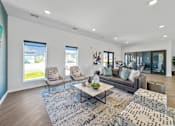 Thumbnail 40 of 57 - a living room with couches and chairs and a rug at Rialto Townhomes Apartments, Iowa, 50263
