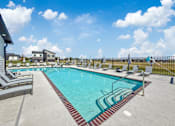 Thumbnail 47 of 57 - our apartments have a resort style pool with lounge chairs at Rialto Townhomes Apartments, Iowa