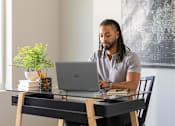 Thumbnail 13 of 57 - a man sitting at a desk with a laptop computer at Rialto Townhomes Apartments, Waukee, 50263