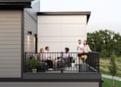 Thumbnail 37 of 57 - a group of people standing on a balcony at Rialto Townhomes Apartments, Waukee, IA, 50263