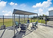 Thumbnail 48 of 57 - a patio with a table and chairs and a canopy at Rialto Townhomes Apartments, Waukee, Iowa