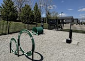 Thumbnail 35 of 50 - A playground with a green sign that says "Stonegate" and a green barrel.