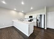 Thumbnail 38 of 51 - A kitchen with white cabinets and a stainless steel refrigerator.