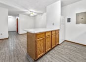 Thumbnail 8 of 53 - A kitchen area with a wooden island and a refrigerator.