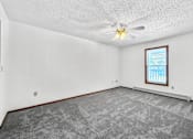 Thumbnail 17 of 53 - A room with a ceiling fan and a window with blinds.
