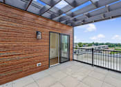 Thumbnail 48 of 77 - Private balcony with pergola and city views at The Flats at West Glen Apartments, Iowa