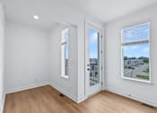 Thumbnail 63 of 77 - Bright room with door to private balcony at The Flats at West Glen Apartments, West Des Moines, IA 50266