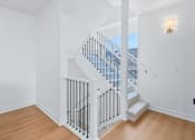 Thumbnail 56 of 77 - Two story staircase with modern black railings at The Flats at West Glen Apartments, Iowa