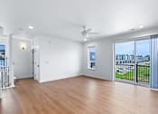 Thumbnail 50 of 77 - Open living space with balcony and wood flooring at The Flats at West Glen Apartments, West Des Moines, 50266