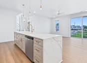 Thumbnail 49 of 77 - Open concept kitchen island with waterfall countertop at The Flats at West Glen Apartments, West Des Moines
