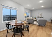Thumbnail 6 of 53 - A dining room with a table and chairs.