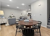 Thumbnail 7 of 53 - A modern dining room with a round wooden table and chairs.