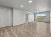 Thumbnail 6 of 53 - A room with wooden flooring and white walls.
