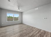 Thumbnail 10 of 53 - Empty room with a window showing an outdoor view.