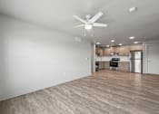 Thumbnail 9 of 53 - A room with a ceiling fan and wooden flooring.