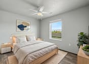 Thumbnail 22 of 53 - A bedroom with a large bed and a ceiling fan.