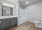 Thumbnail 18 of 53 - A white toilet sits in a bathroom with a walk-in shower.