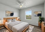 Thumbnail 25 of 53 - A bedroom with a large bed, a ceiling fan, and a window with a view of the outdoors.