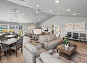 Thumbnail 51 of 53 - A spacious living room with a variety of seating options and a dining table.