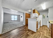 Thumbnail 12 of 53 - A kitchen with white appliances and wooden floors.