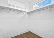 Thumbnail 26 of 36 - A spacious, walk-in closet with plenty of shelving. Along with a window for natural light.