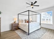Thumbnail 6 of 36 - A  very spacious primary bedroom with tons of windows with natural light and a ceiling fan.
