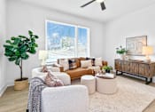 Thumbnail 4 of 36 - A spacious living room with a couch, chair, and potted plant.