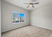 Thumbnail 7 of 34 - Spacious bedroom with ceiling fan