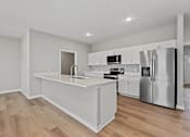 Thumbnail 12 of 53 - A modern kitchen with stainless steel appliances and white cabinetry.