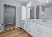 Thumbnail 22 of 53 - A bathroom with a sink, mirror, and cabinets.