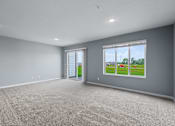 Thumbnail 24 of 53 - A spacious room with grey walls and carpeted floor.