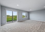 Thumbnail 23 of 53 - A room with grey walls and a carpeted floor with a sliding glass door.