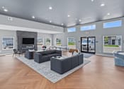 Thumbnail 5 of 53 - A spacious living room with a grey sofa set and a television.