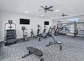 Thumbnail 40 of 53 - A spacious gym with a variety of equipment including treadmills, exercise bikes, and weight machines.