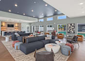 Thumbnail 9 of 53 - A modern living room with a grey sofa set and a wooden floor.