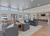 Thumbnail 44 of 53 - A modern living room with grey couches and a wooden coffee table.