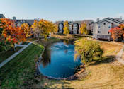 Thumbnail 40 of 51 - an aerial view of a pond with houses in the background at 92West, Iowa  